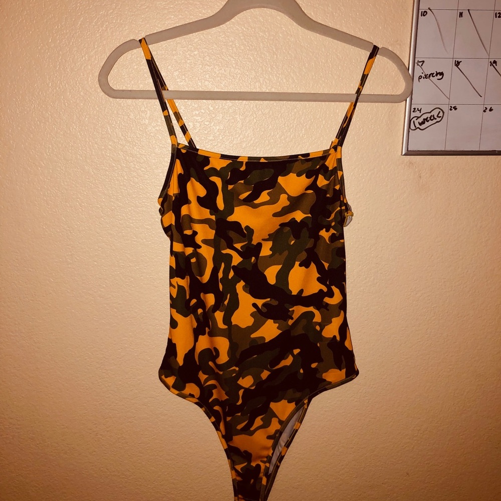 A camouflage button body suit